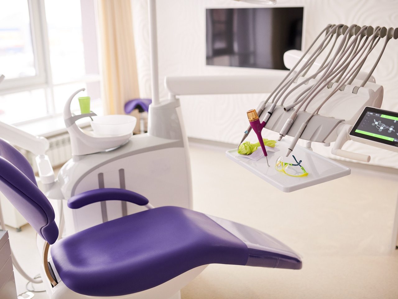 Background image of empty dentists office with purple dental chair, copy space